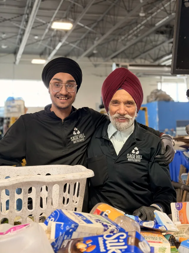 Two members of the Sage Hill team smiling behind the sorting counter